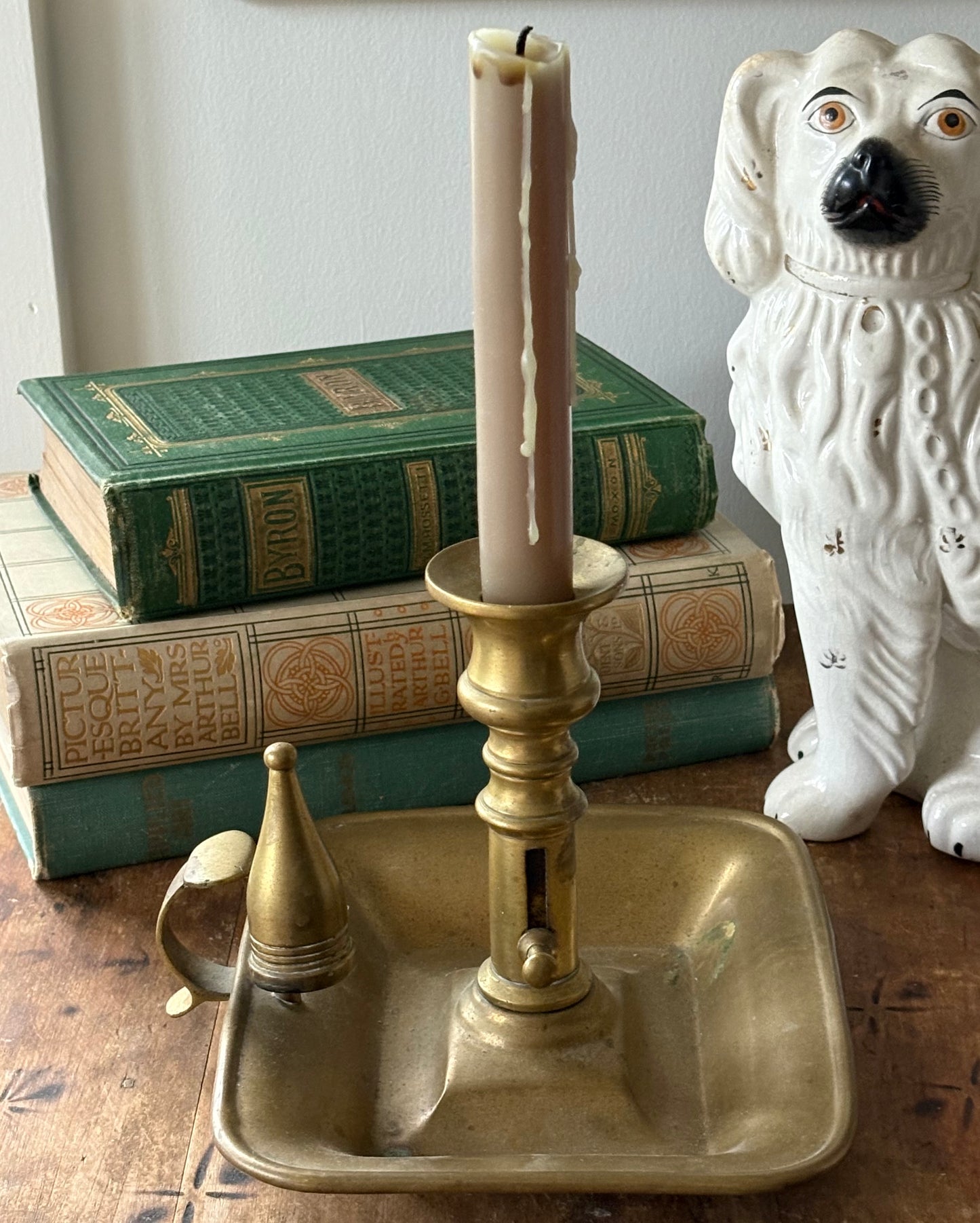antique brass chamberstick-style candleholder with douter