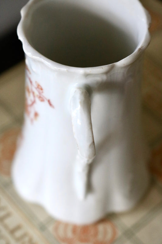 antique small porcelain pitcher with floral design