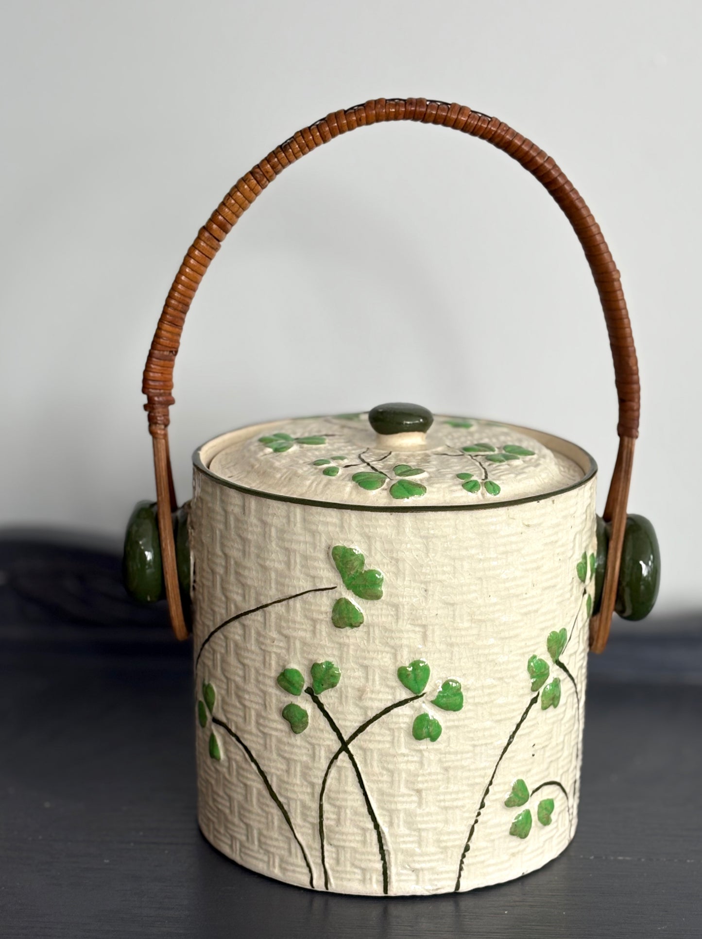 vintage ceramic biscuit jar with rattan handle and Shamrock design