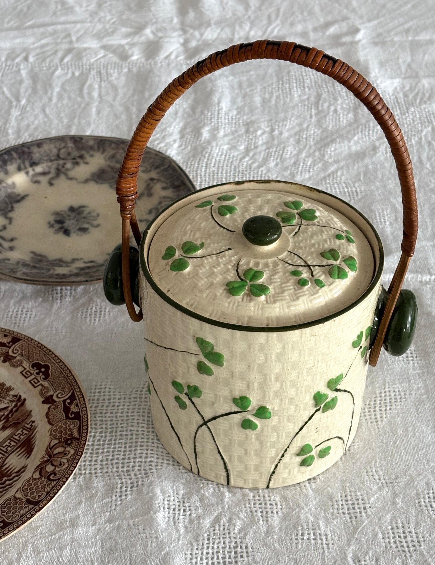 vintage ceramic biscuit jar with rattan handle and Shamrock design