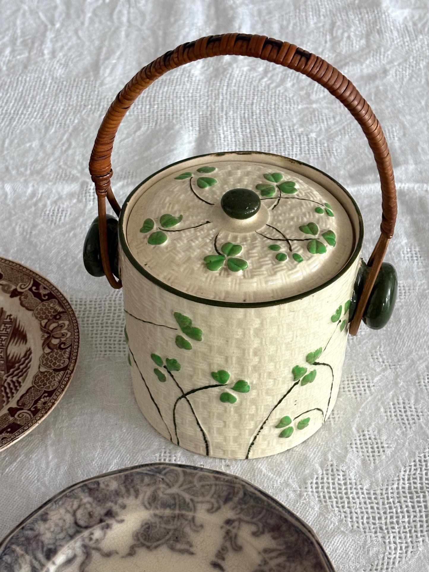 vintage ceramic biscuit jar with rattan handle and Shamrock design