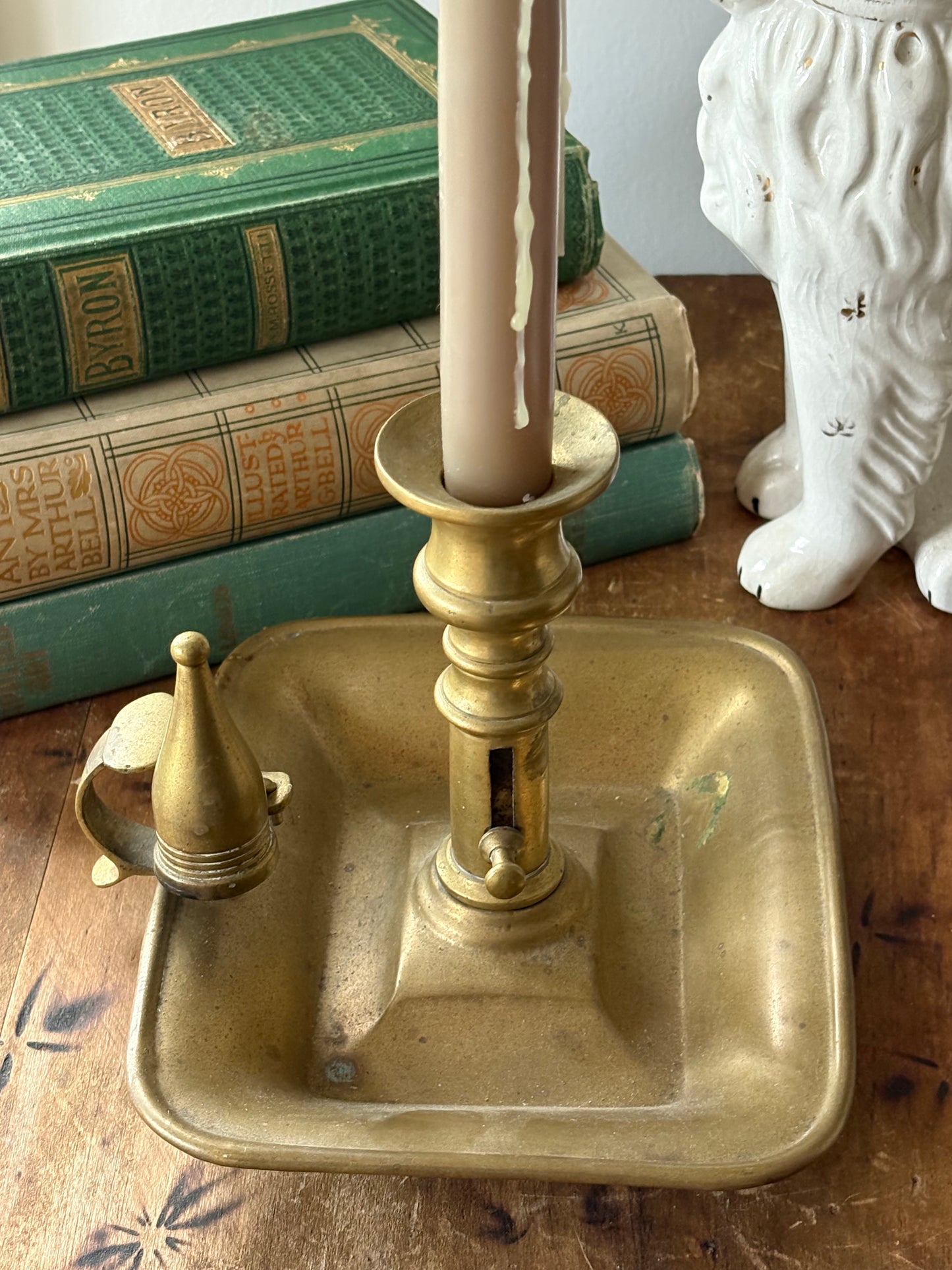 antique brass chamberstick-style candleholder with douter